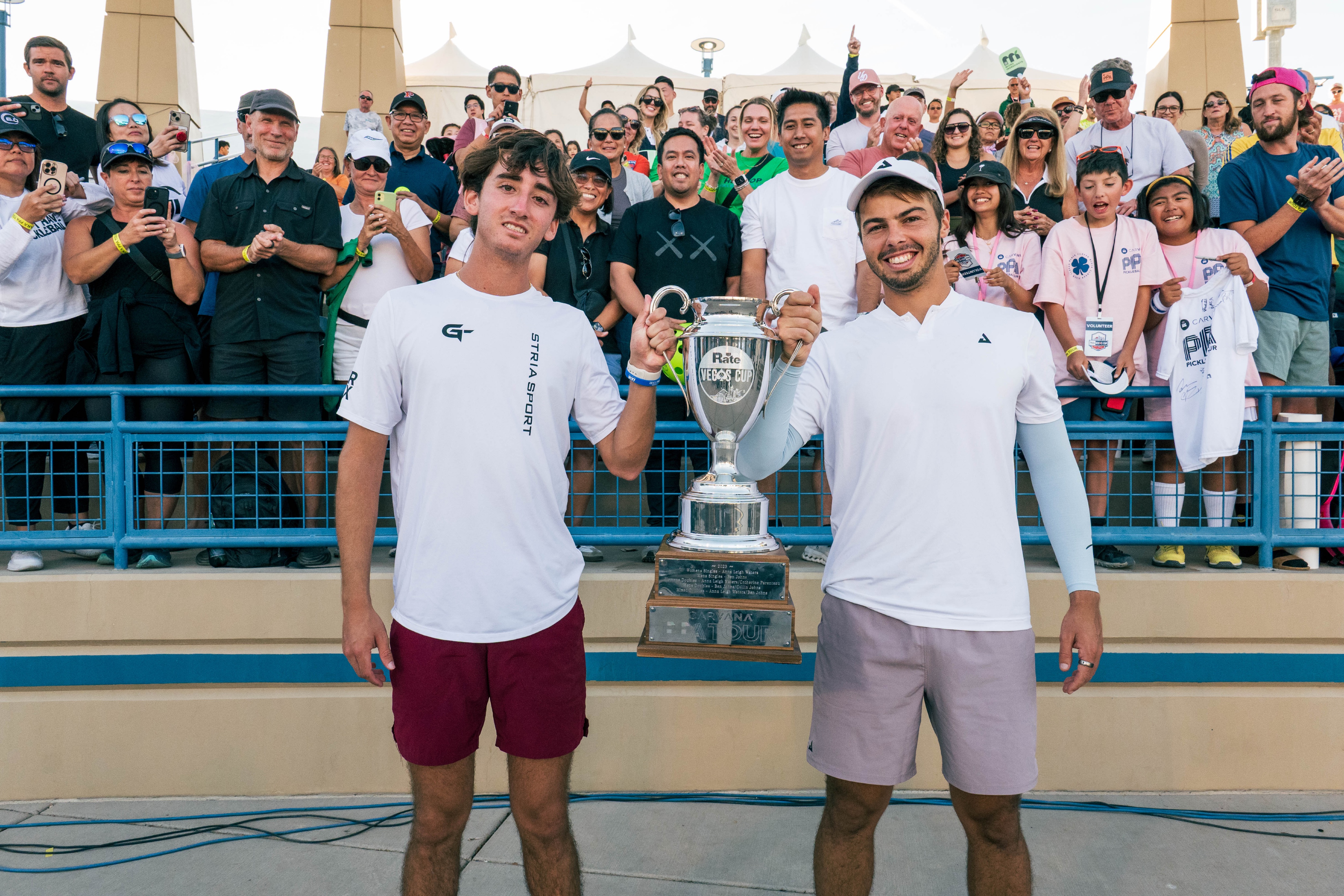 Tardio and Johns Hoist the Trophy After Completing a Grueling Five Game Final